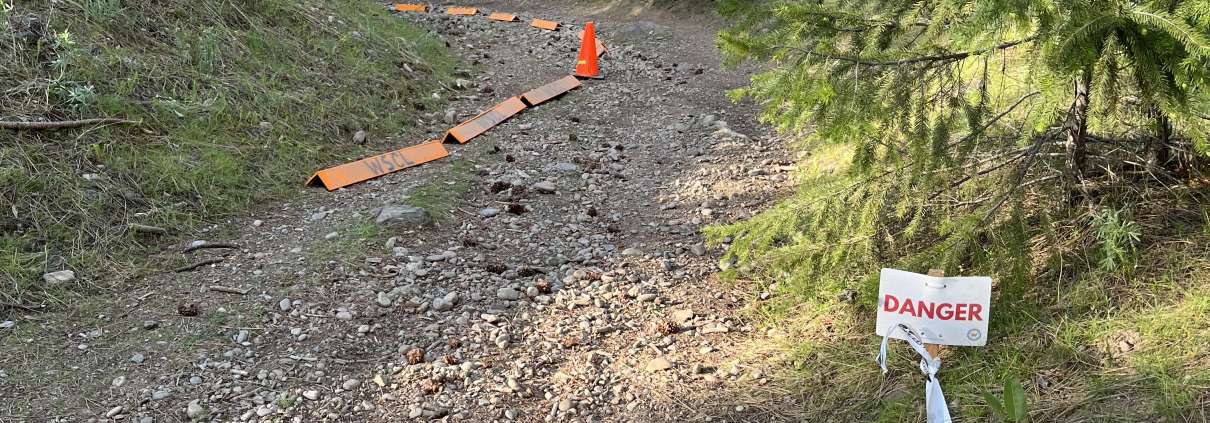 mountain trail with "danger" sign
